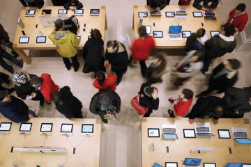 tables with laptops and people