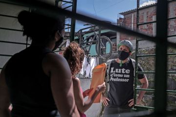 man delivers envelope with a  face mask on