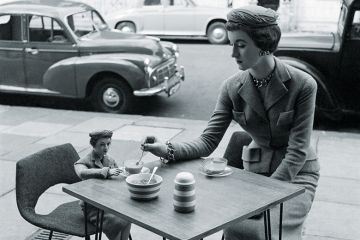 Woman sitting at a cafe with her miniature Woman sitting at a cafe with her miniature