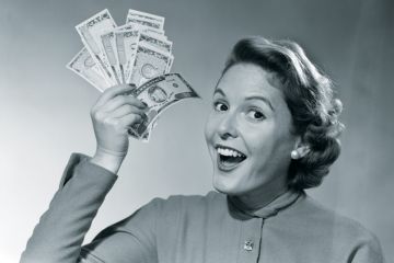 Woman holding handful of cash (black and white)