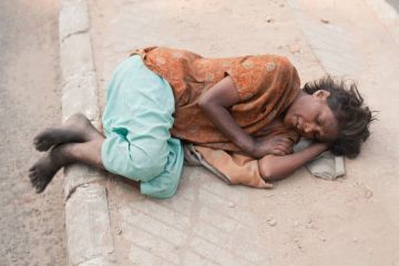 Woman lying on pavement, Delhi Woman lying on pavement, Delhi