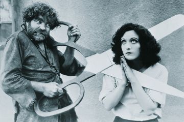 Woman with giant scissors round her neck