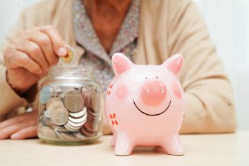 woman counting coins money with piggy bank woman counting coins money with piggy bank