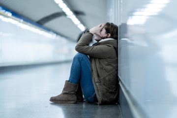 Woman with head in hands