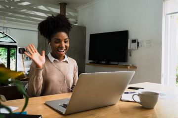 Woman working from home, on a video call with work colleagues