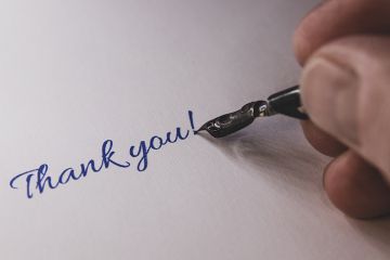 Close-up of a hand from a person writing thank you with a fountain pen Close-up of a hand from a person writing thank you with a fountain pen