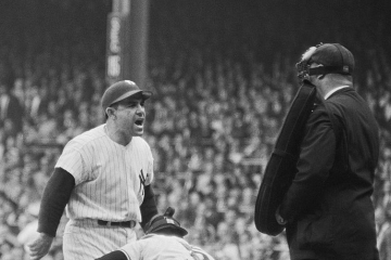 Yogi Berra bellows at the umpire in the 1962 baseball World Series, illustrating dismay at proposals to close language departments