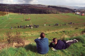 Young men watching rugby match, Cefn coed RFC Young men watching rugby match, Cefn coed RFC