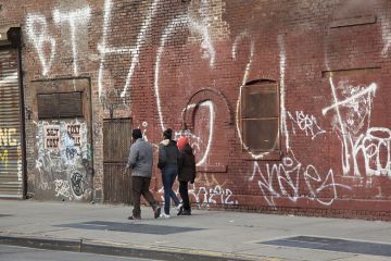 Young people walk in rundown neighbourhood Young people walk in rundown neighbourhood