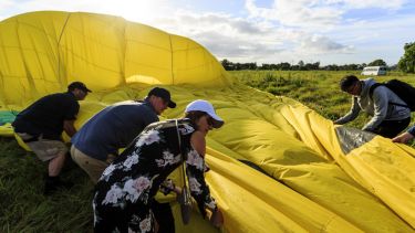 Helping the ground crew folding up the balloon