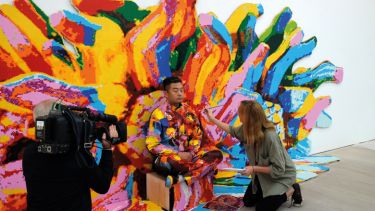 Artist Liu Bolin mid-way painting through his first live UK performance The Disappearing Act in London's Saatchi Gallery