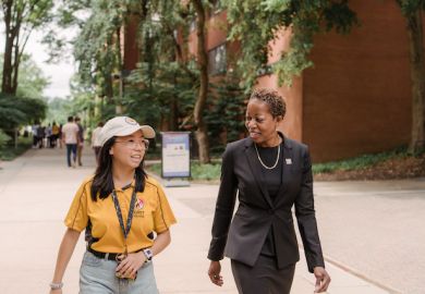 Valerie Sheares Ashby, president of the University of Maryland, Baltimore County, walks with a student on campus