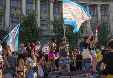 14.08.2021 Romania - Bucharest. A transsexual waving the trans pride flag on the stage set up at the University, at the lgbt pride parade.