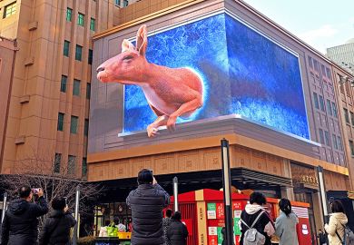 People take photos of a naked-eye 3D kangaroo appearing on an outdoor screen in Beijing, China. As an illustration that offshore education by Australian universities in China can require conditions that would never be tolerated at home. People take photos of a naked-eye 3D kangaroo appearing on an outdoor screen in Beijing, China. As an illustration that offshore education by Australian universities in China can require conditions that would never be tolerated at home.