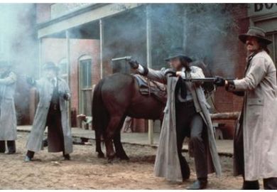 Gunslingers/cowboys fire their guns Gunslingers/cowboys fire their guns