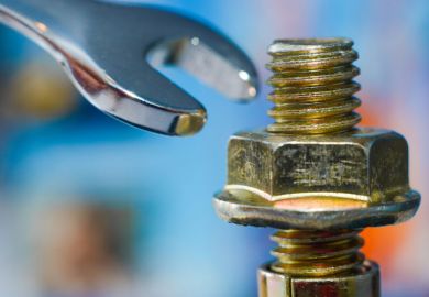 Spanner being used to tighten a nut