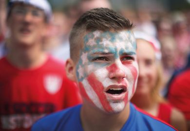 Young man with American flag painted on face