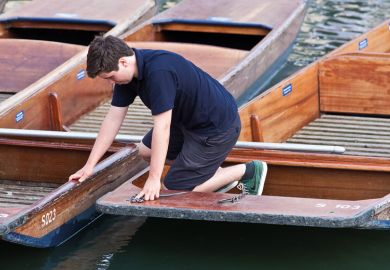 A boy working on the punts at the University of Cambridge