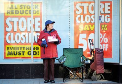 A charity collector standing outside a shop