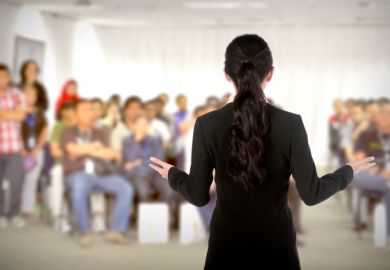 A female speaker addressing a conference