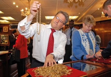 A man inspecting gold jewellery