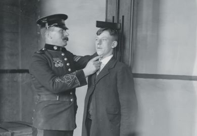 A man measuring the height of another man A man measuring the height of another man