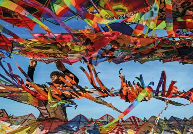 A man surrounded by colourful kites