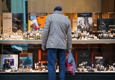 Window shopper looking at luxury watches