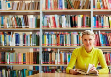 A woman sitting in a library