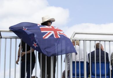 A happy Australian male with the Australian Flag, happy that his Team won the 2021 Catamaran Sail GP event held in denmark for the first time in Scandinavia