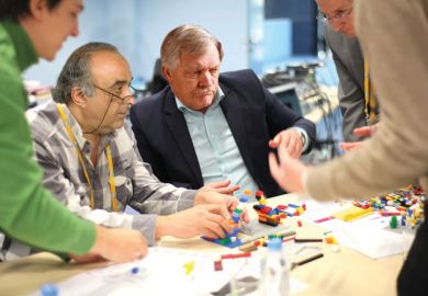 Adults playing with Lego Adults playing with Lego