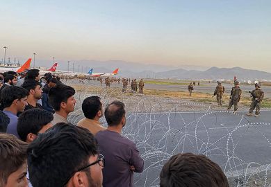 Afghans crowd at the airport as US soldiers stand guard in Kabul in August 2021