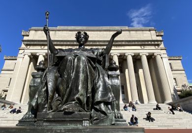 Alma Mater statue by Daniel Chester French in front of students sitting on the Low Library steps on Columbia University's main campus