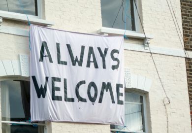 a banner hangs at the front of a London house with the caption 'Always Welcome' a banner hangs at the front of a London house with the caption 'Always Welcome'