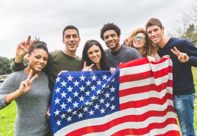 American students posing with USA stars and stripes flag American students posing with USA stars and stripes flag