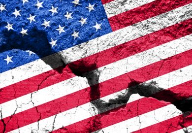 An American flag with a big crack through it An American flag with a big crack through it