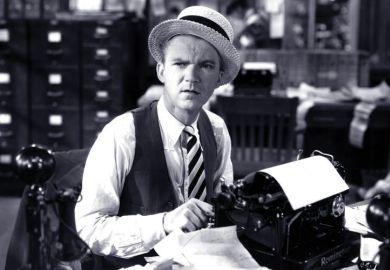 An editor sitting at a typewriter An editor sitting at a typewriter
