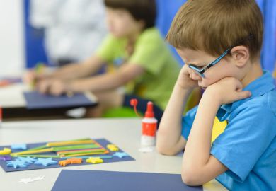 Angry kid looking at his craft at kindergarten