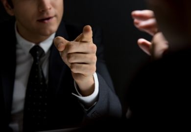 An angry official points his finger, symbolising the Trump Administration