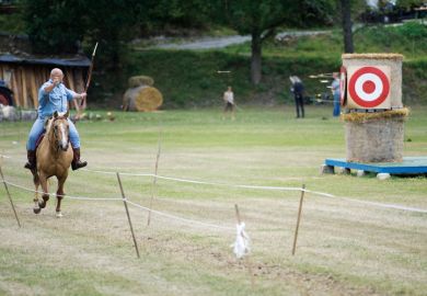 Archer firing arrow from horseback