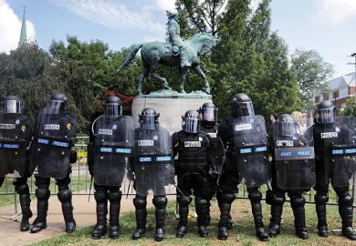 Armoured state police guarding statue