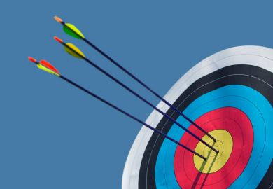 Arrows shot into archery target bullseye