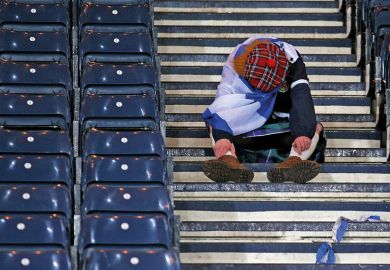 A Scot sitting down on some steps