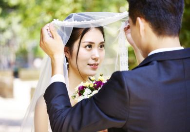 Asian bride and groom illustrating article about a Chinese province organising speed-dating events to encourage graduates to stay in the region, match-making, marriage