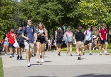 Athens, Georgia - August 27, 2021 Students walking on campus at the University of Georgia. As of the beginning of the Fall semester, the university was recommending but had not mandated the wearing of masks or vaccinations against COVID-19.