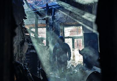 First responders work in a building that was struck by a rocket attack in Kharkiv, Ukraine on March 15, 2022