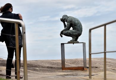 A visitor takes a picture of a sculpture by British artist Laurence Edwards at the “Sculpture by the Sea” exhibition that runs along the Bondi to Tamarama coastal walk in Sydney, 22 October 2015