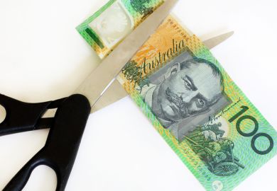 Australian dollars cut with scissors