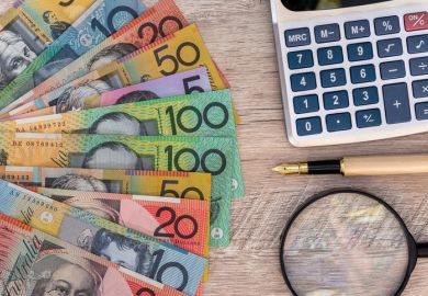 Australian dollars with calculator, pen and magnifier