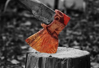 Axe on a block of wood with £50 banknote on the axe head. To illustrate the cost of severance pay.